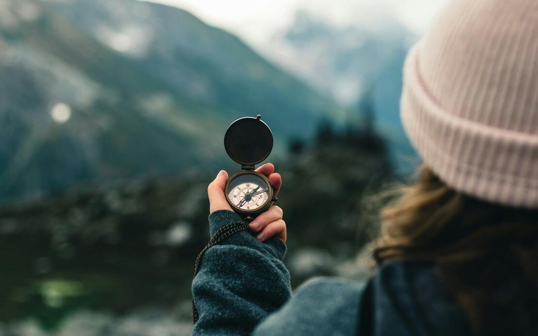 Woman hiking using compass